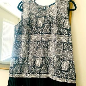 Tommy Hilfiger black and white sleeveless blouse with pleats at the bottom.